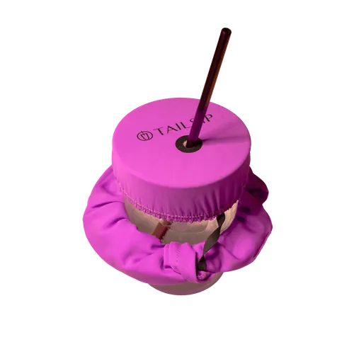 Glass covered with the fuchsia Tailsip scrunchie and a straw